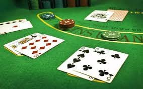 Mobile phone displaying pulautoto slot card games lobby with multiple tables